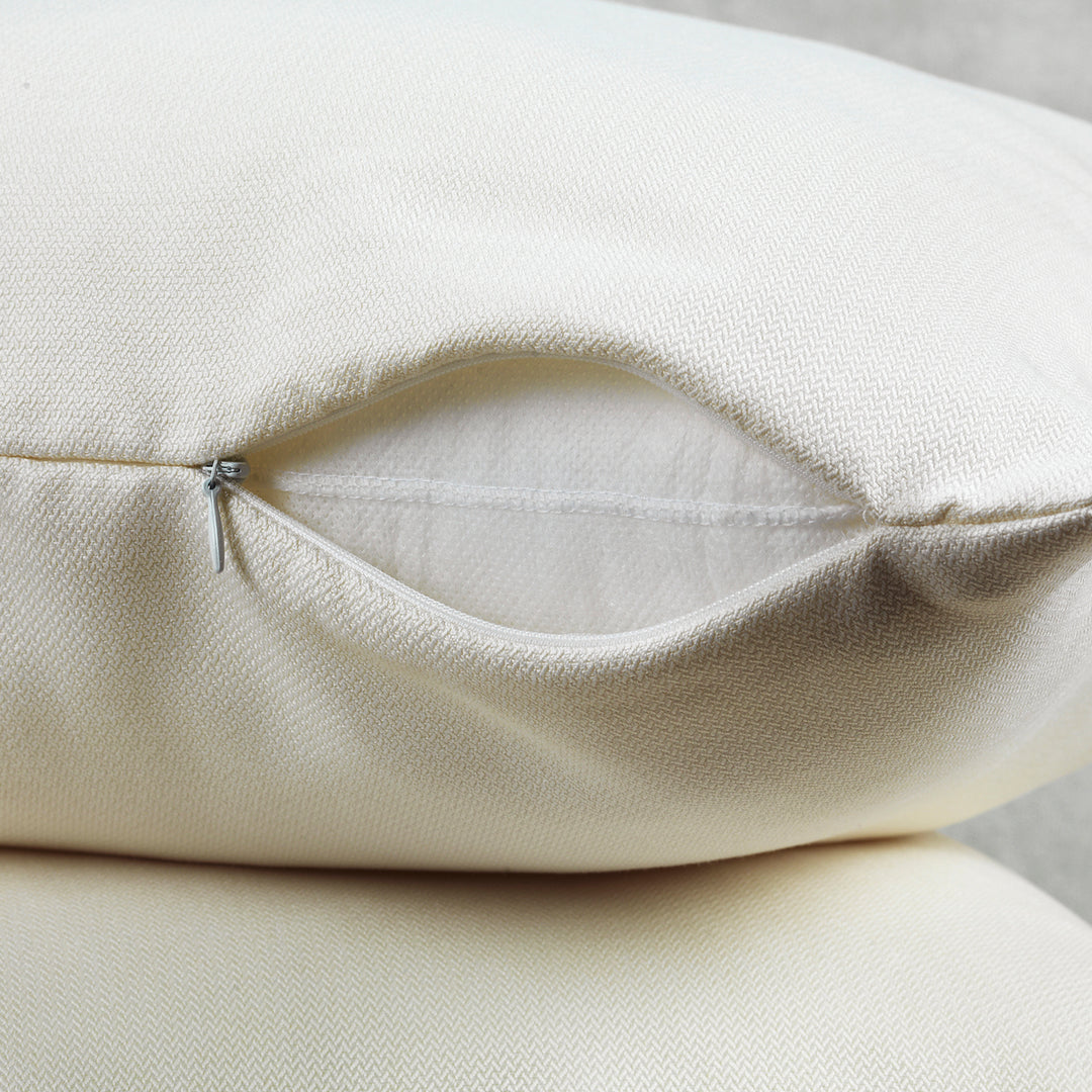 A made to measure cushion cover in soft cream linen‑look fabric, shown with an invisible zipper and a natural textured weave for a polished premium finish
