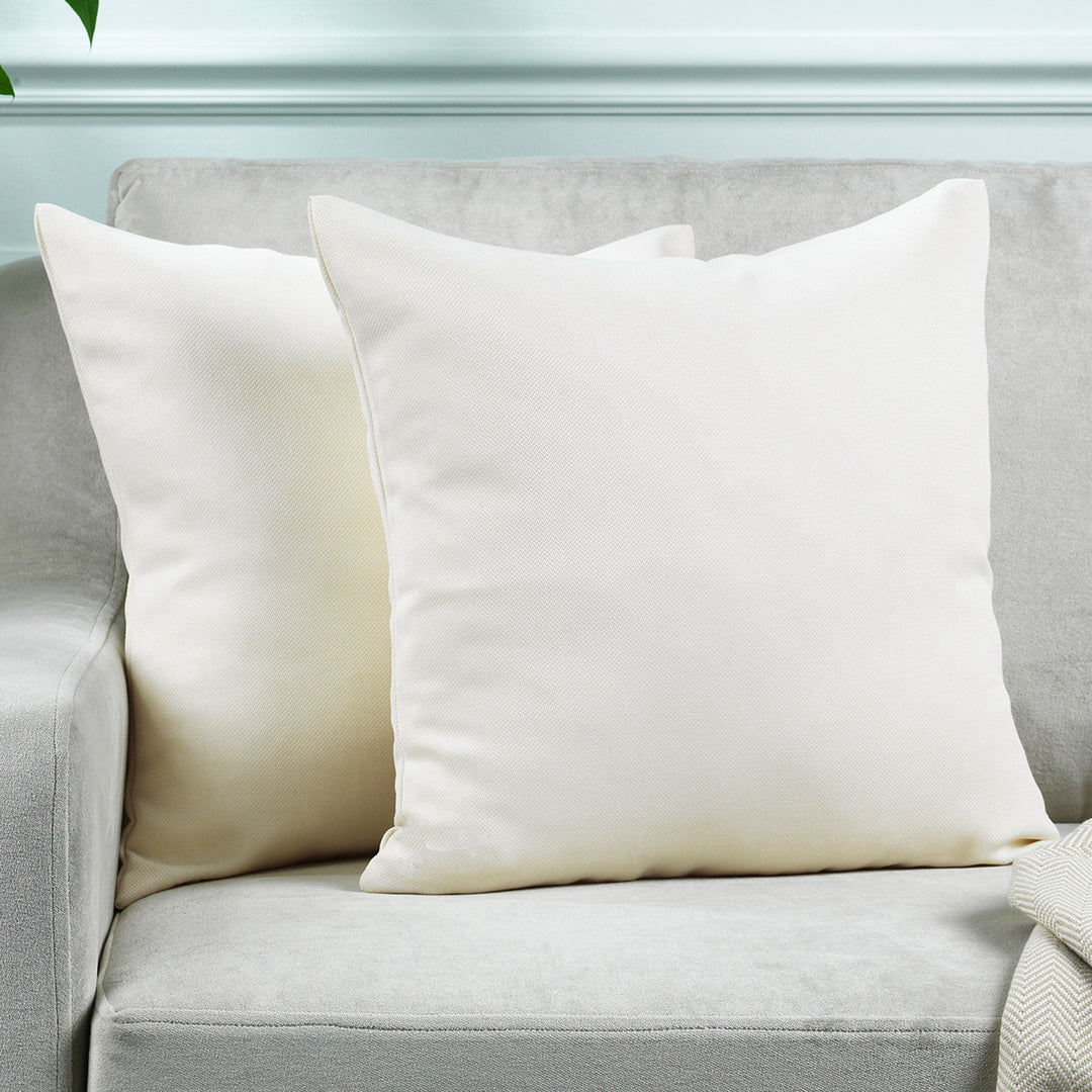 A made to measure cushion cover in soft cream linen‑look fabric, featuring a subtle woven texture and clean tailored edges for a light elegant appearance