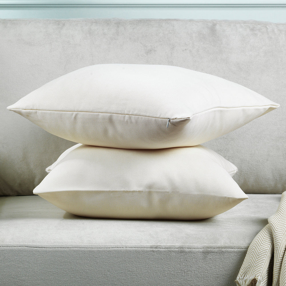 A made to measure cushion cover in soft cream linen‑look fabric, displayed from the side with a natural woven texture and neatly finished seams for a refined clean look