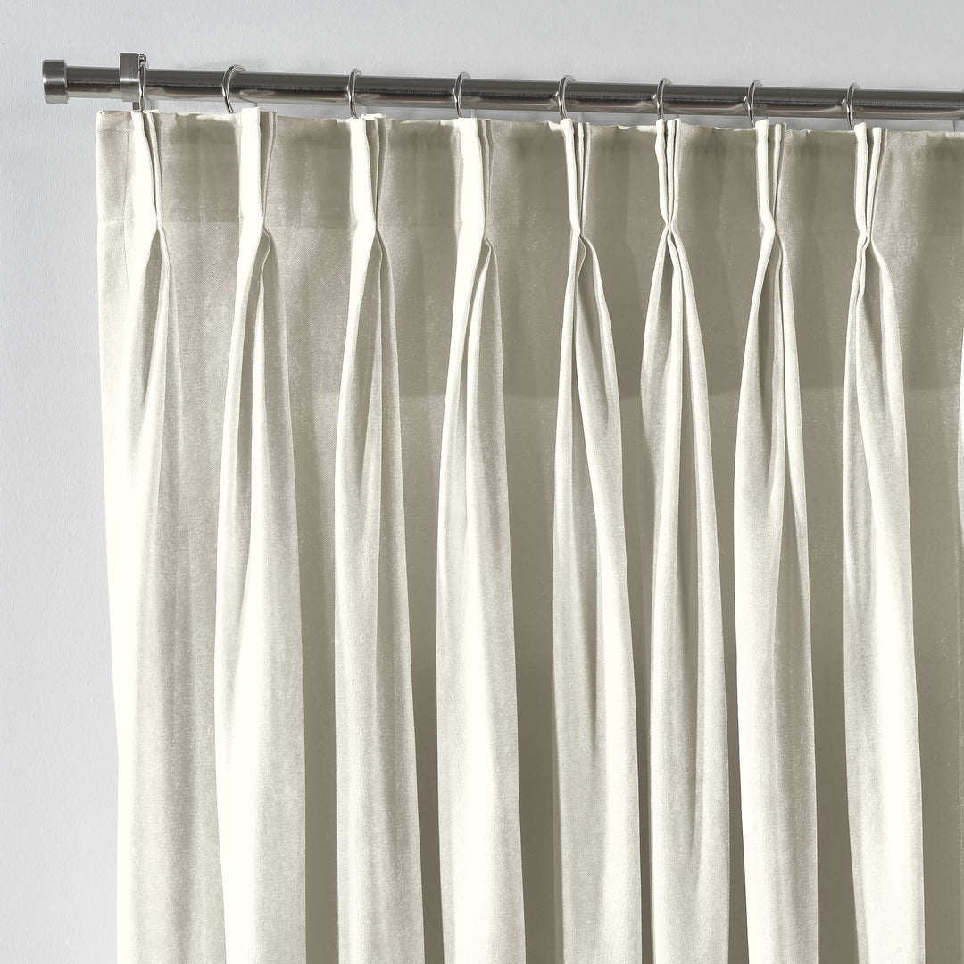 Cream shiny velvet pinch pleat curtain with crisp tailored pleats and a soft, flowing silhouette.