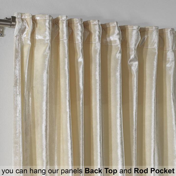 Close‑up of cream glossy velvet fabric featuring fine texture and a soft, elegant surface.