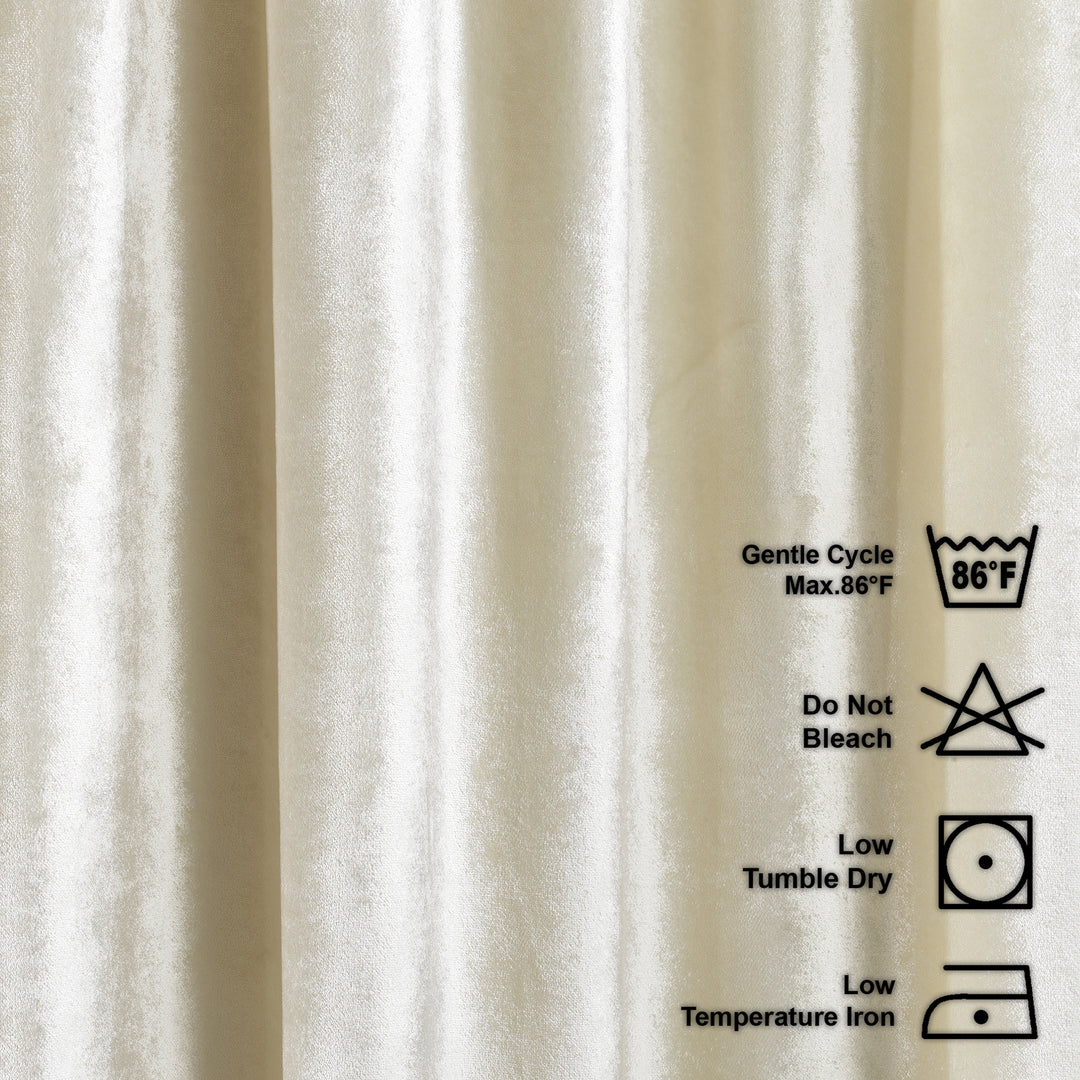 cream shiny velvet fabric with laundry care labels on a beige background