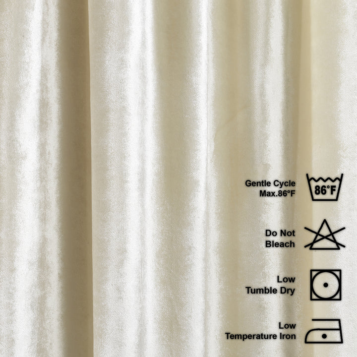 cream shiny velvet fabric with laundry care labels on a beige background