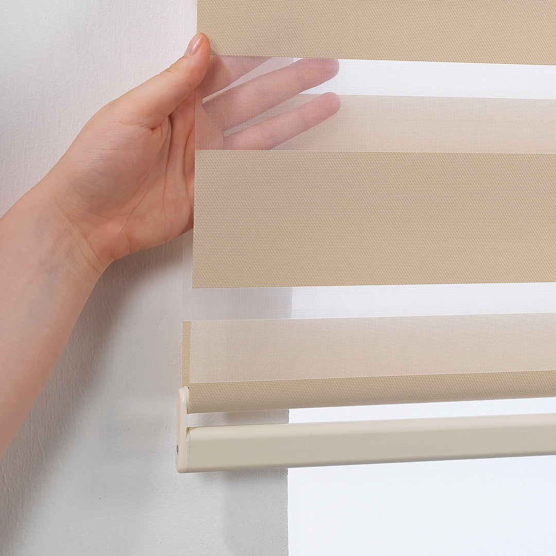Made to measure cream zebra roller blind featuring warm-toned alternating sheer and dim‑out stripes for soft light control and balanced privacy, highlighting its gentle creamy shade, smooth woven texture and elegant contemporary day‑and‑night blind design.