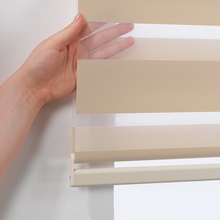Made to measure cream zebra roller blind featuring warm-toned alternating sheer and dim‑out stripes for soft light control and balanced privacy, highlighting its gentle creamy shade, smooth woven texture and elegant contemporary day‑and‑night blind design.