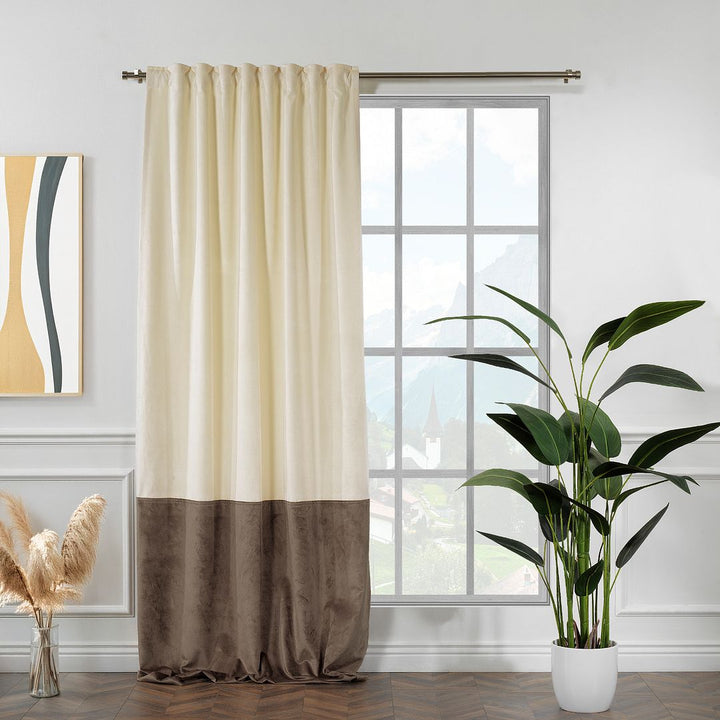 A made to measure matte velvet block curtain in cream and cappuccino, shown with soft draping folds and a refined two‑tone finish