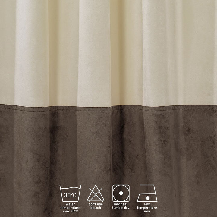 A made to measure matte velvet block curtain in cream and cappuccino, shown with soft draping folds and a refined two‑tone finish