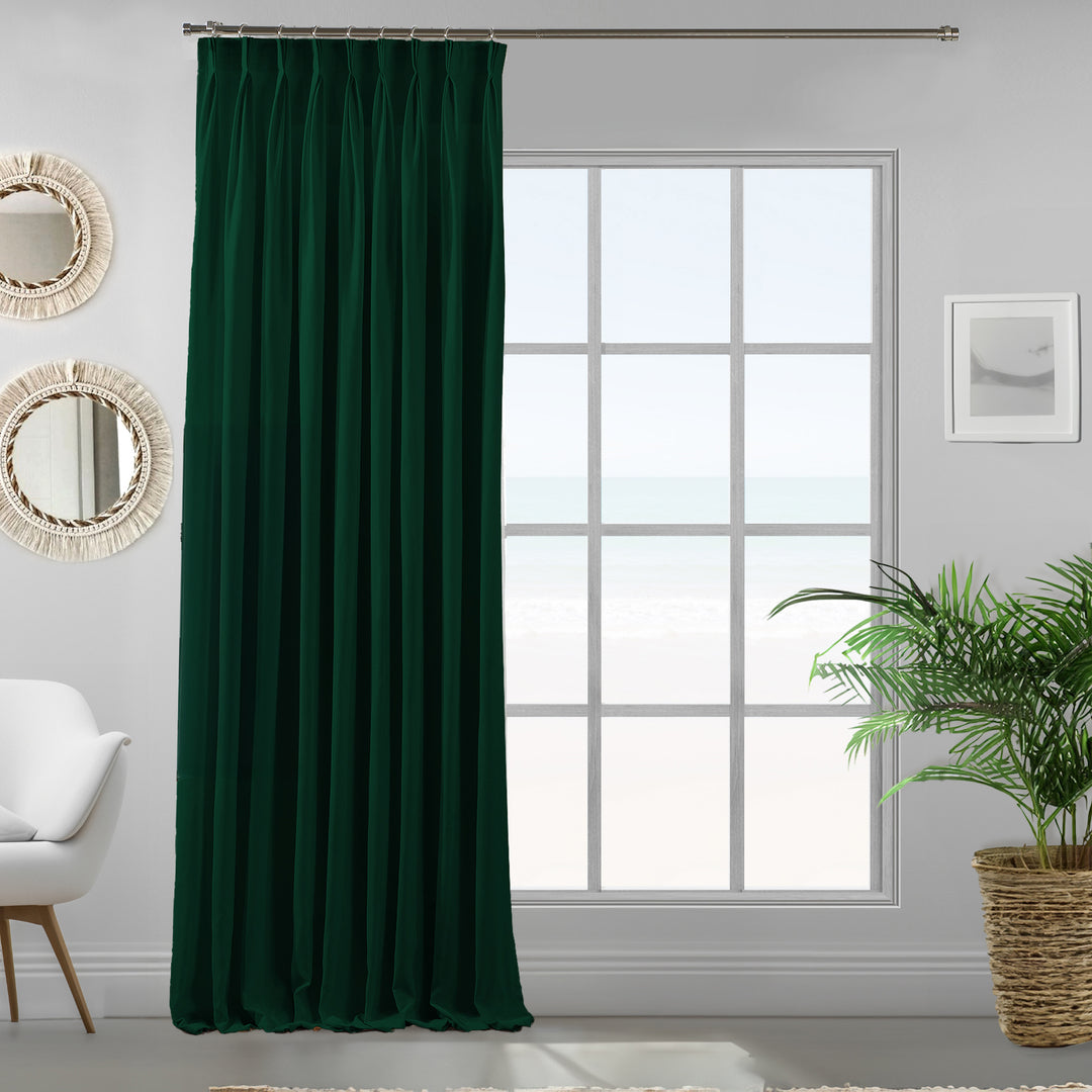 Pinch pleated dark green velour curtain panel showing soft drape and refined matte finish.