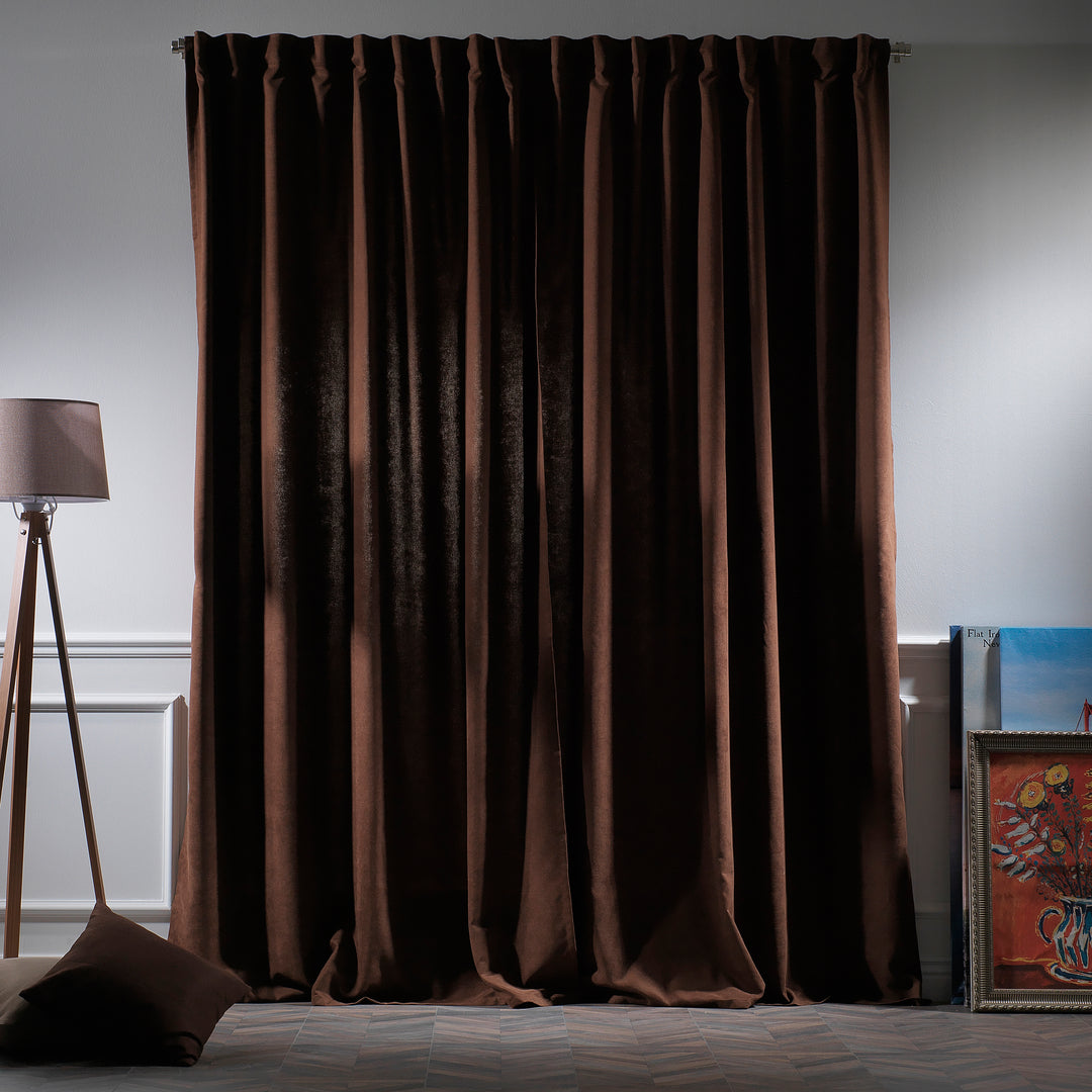 Dark brown velour curtains photographed at night, showing dense weave and elegant deep colour.