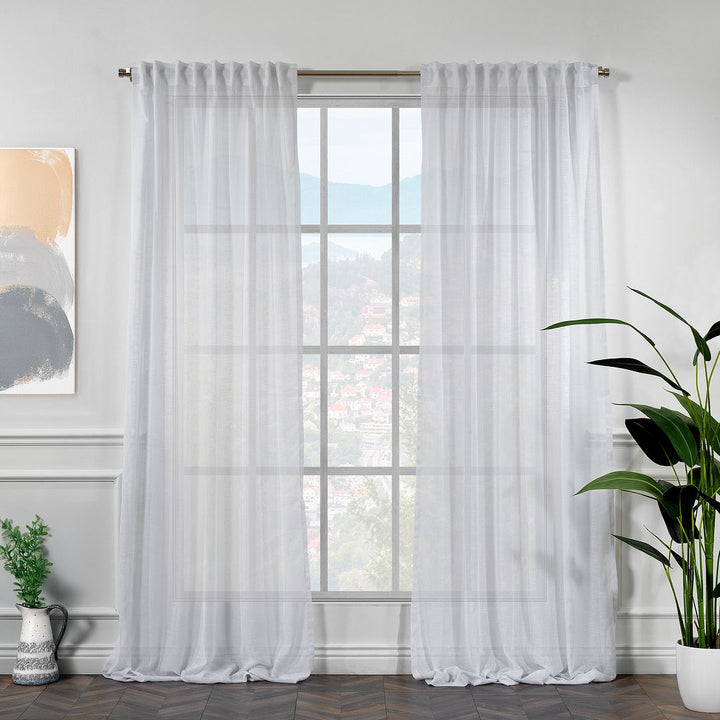 Faux linen sheer white curtains hanging in a room 