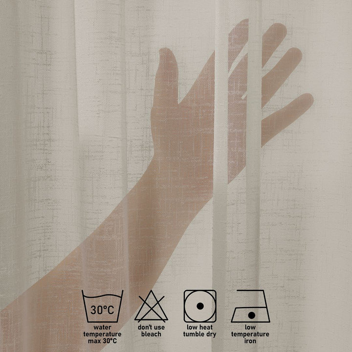 Close-up of beige linen semi sheer with laundry label