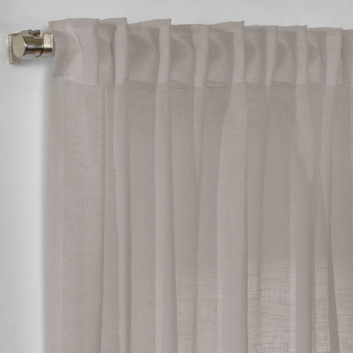 detailed view of the professional stitching and weighted hem on a bespoke brown linen semi-sheer curtains