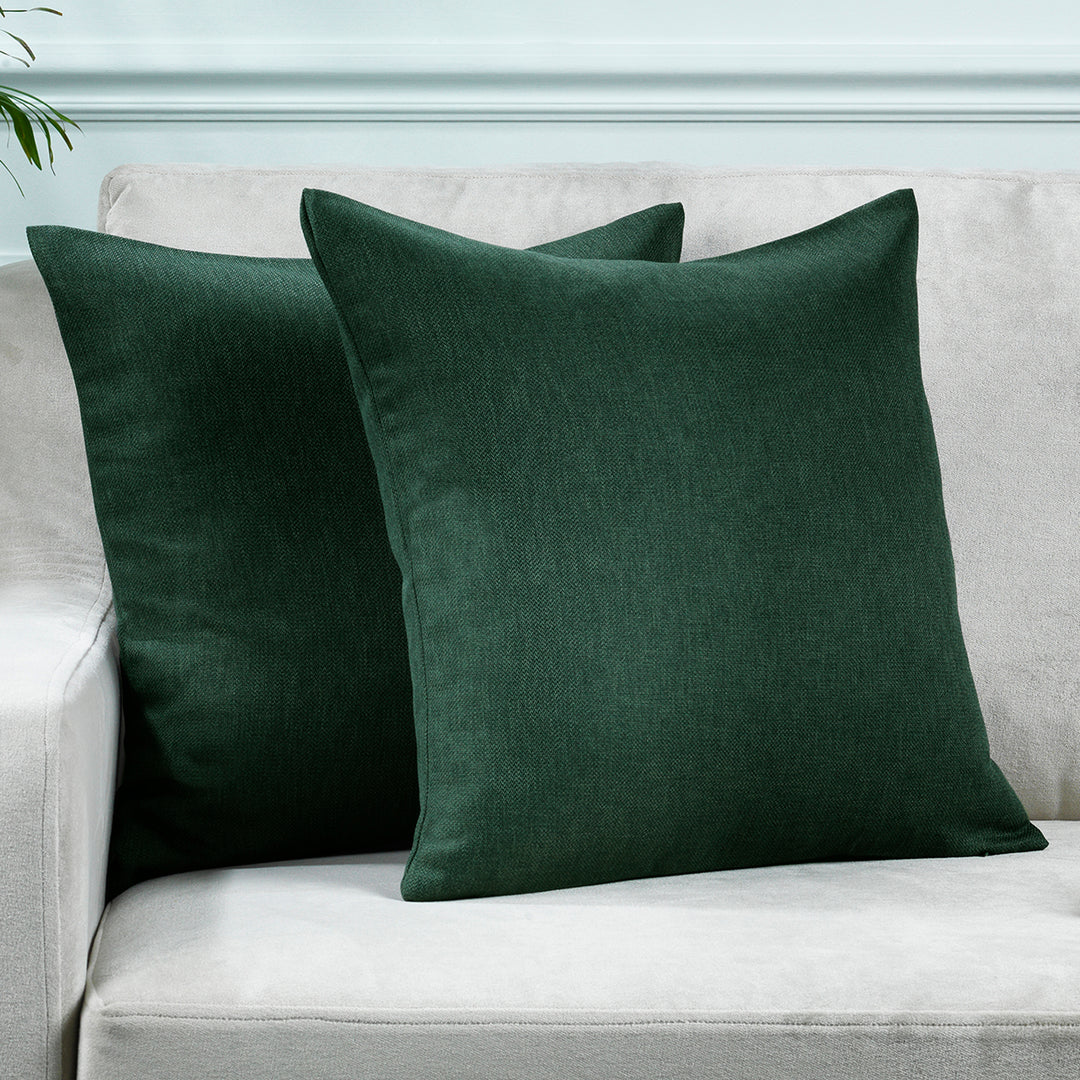 A made to measure cushion cover in deep duck‑green linen‑look fabric, shown with a natural textured weave and crisp refined edges for a rich earthy finish
