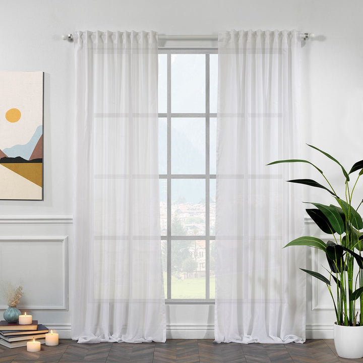 Ecru chiffon semi‑sheer curtain, made to measure in extra‑long and extra‑wide sizing, allowing warm natural light to filter softly through.