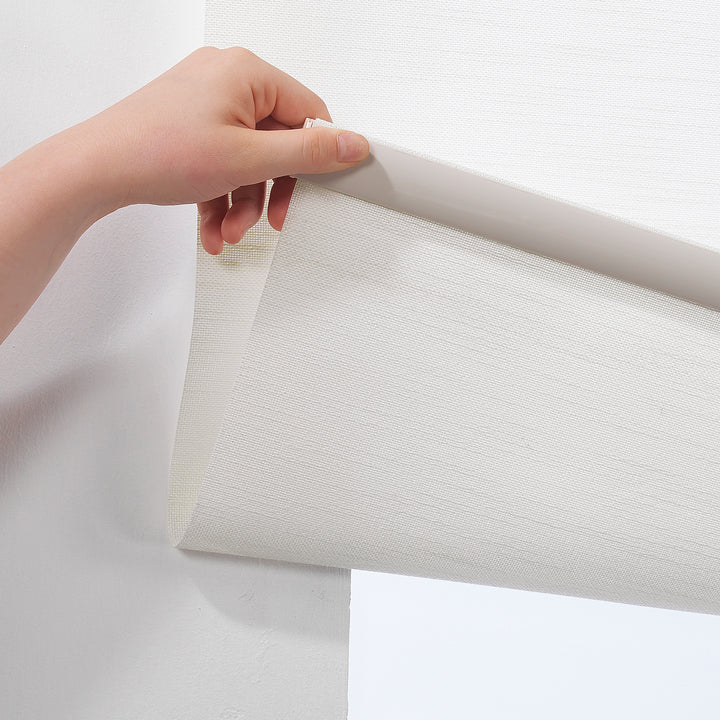 Ecru linen‑look roller blind showing natural fabric detail and smooth daylight filtering.