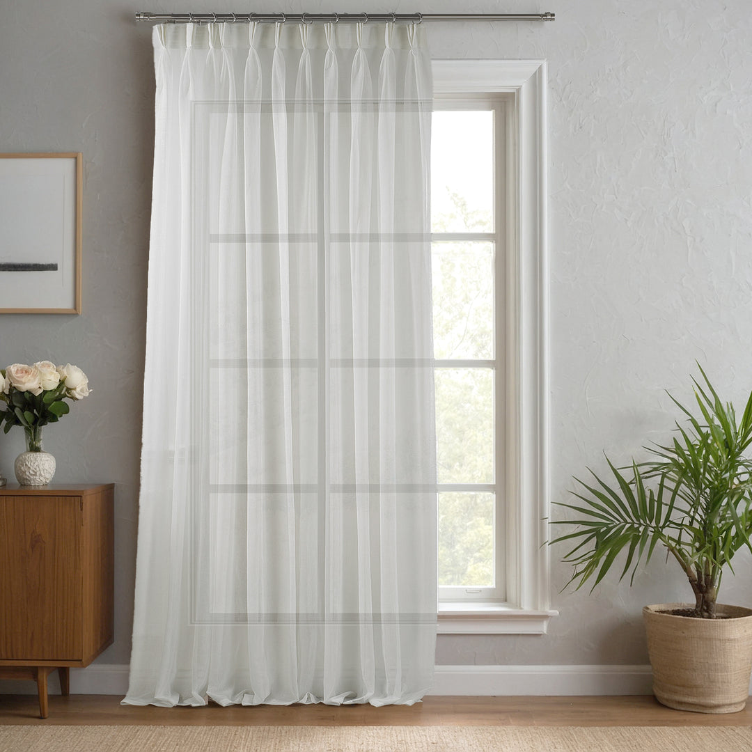 Ecru linen‑sheer curtain made to measure with tailored pinch pleats and warm natural linen texture.
