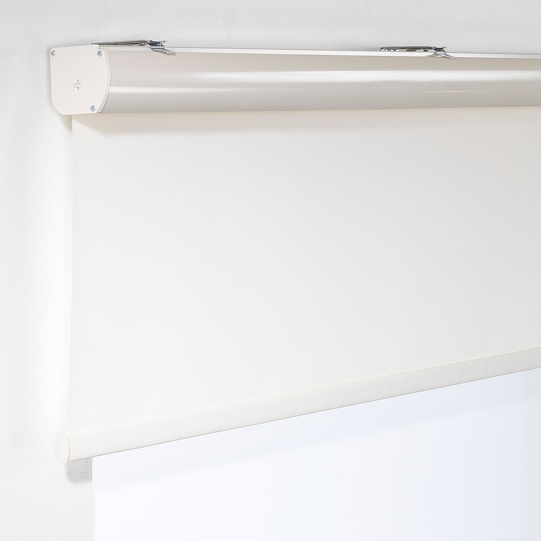 A close‑up of an ecru room darkening roller blind made to measure, showing its soft woven texture and clean refined finish