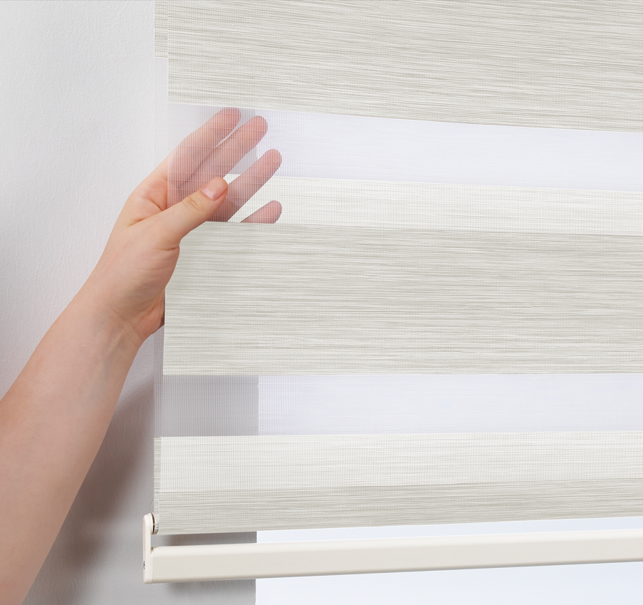 Made to measure zebra roller blind in ecru, featuring alternating sheer and opaque horizontal stripes for adjustable light control and privacy, showcasing the soft neutral tone, smooth texture and contemporary day‑and‑night blind design.