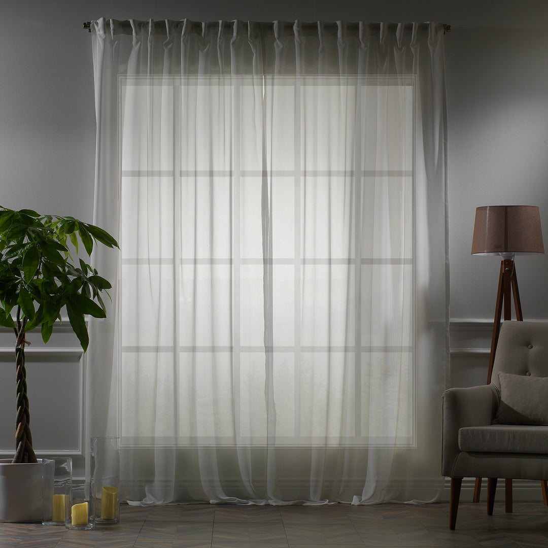Made‑to‑measure extra‑long and extra‑wide Ecru silk‑crepe sheer curtain in evening light, highlighting the fine crepe weave and gentle soft‑glow translucency.