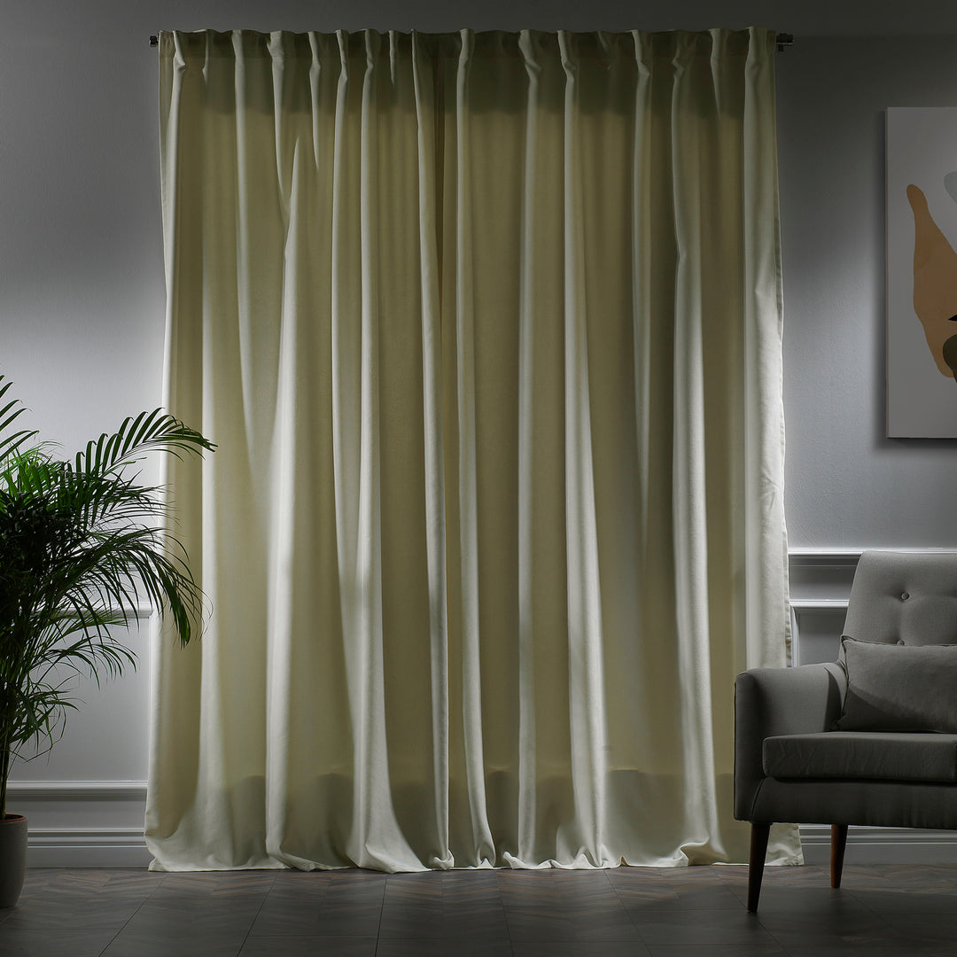 Ecru velour curtains photographed closed, highlighting smooth pile, matte finish and refined tailored fall.