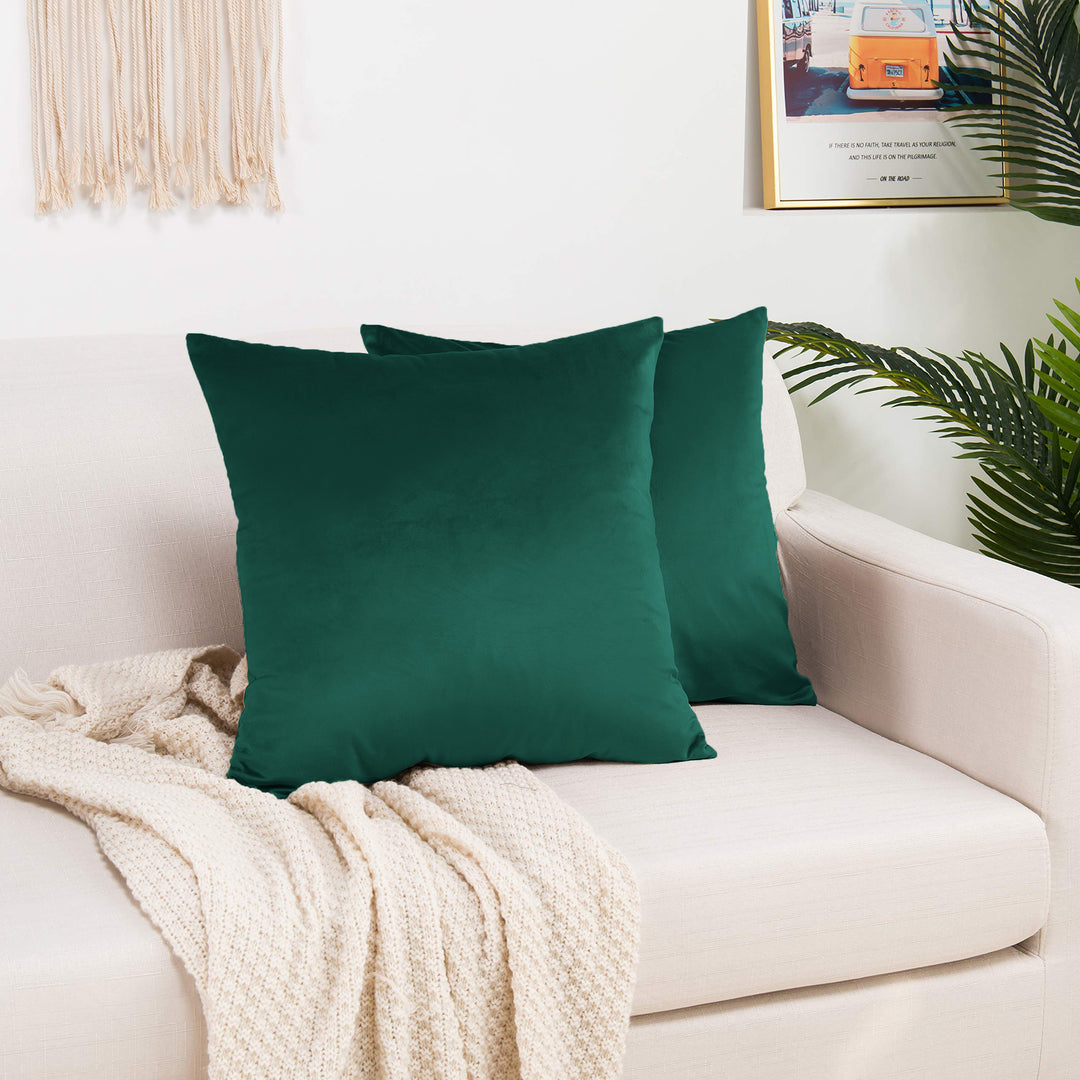 A made to measure cushion cover in vibrant emerald‑green shiny velvet, featuring a glossy velvety surface and refined seams for a luxurious bold look