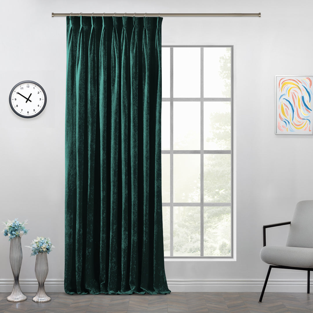 Shiny velvet pinch pleat curtain with polished folds and a long, sculpted tailored drop.