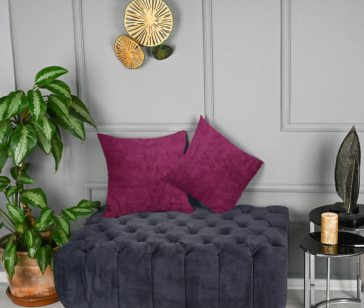 A made to measure cushion cover in vibrant fuchsia matte velvet, featuring a smooth velvety surface and crisp structured seams for a bold premium style