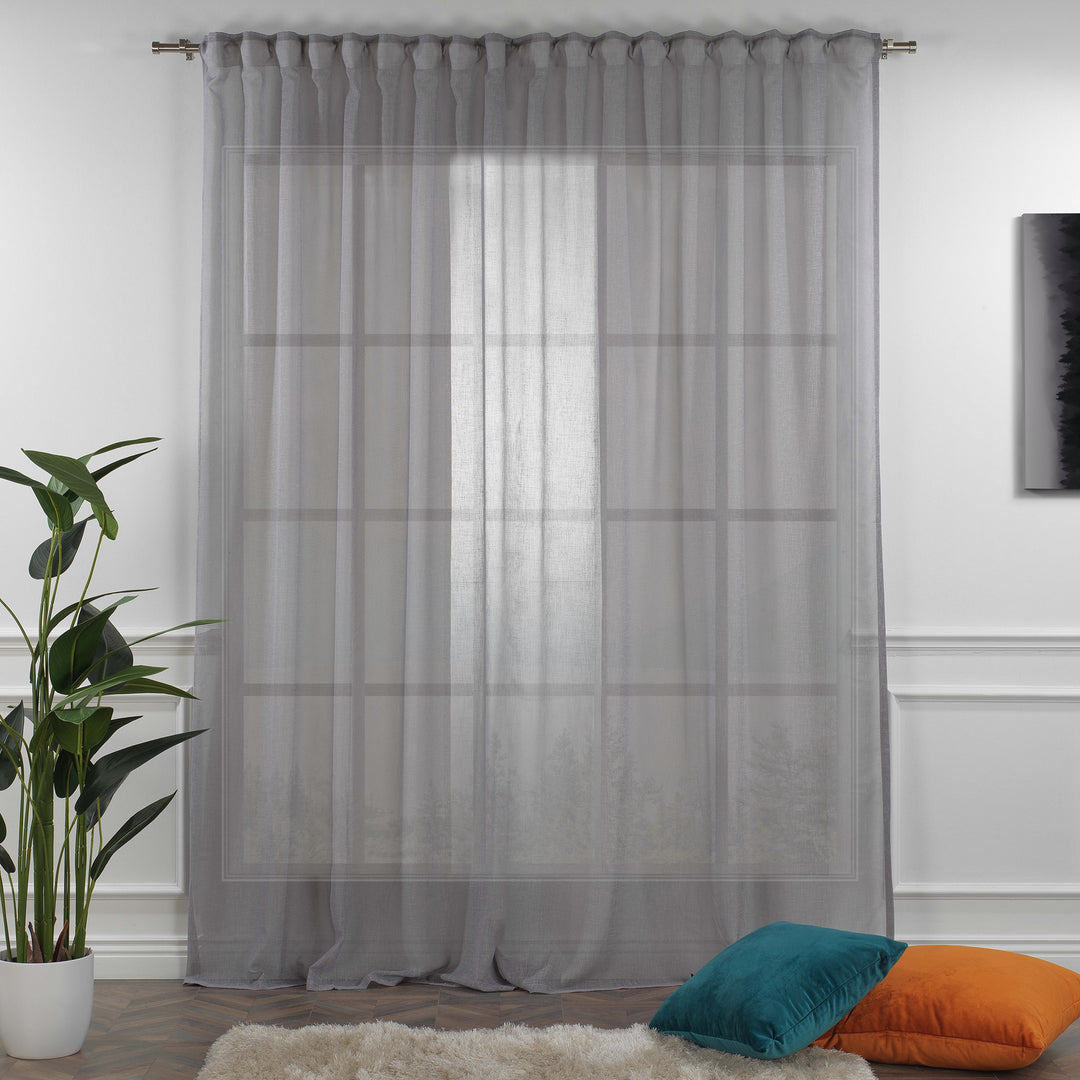 Grey linen sheer curtain fully closed in a contemporary bedroom, soft diffused light and textured linen weave.