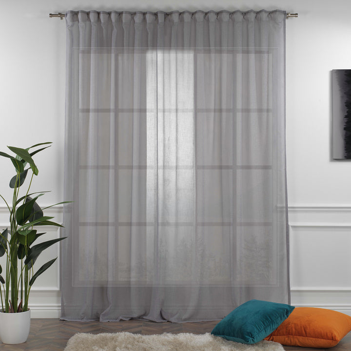 Grey linen sheer curtain fully closed in a contemporary bedroom, soft diffused light and textured linen weave.