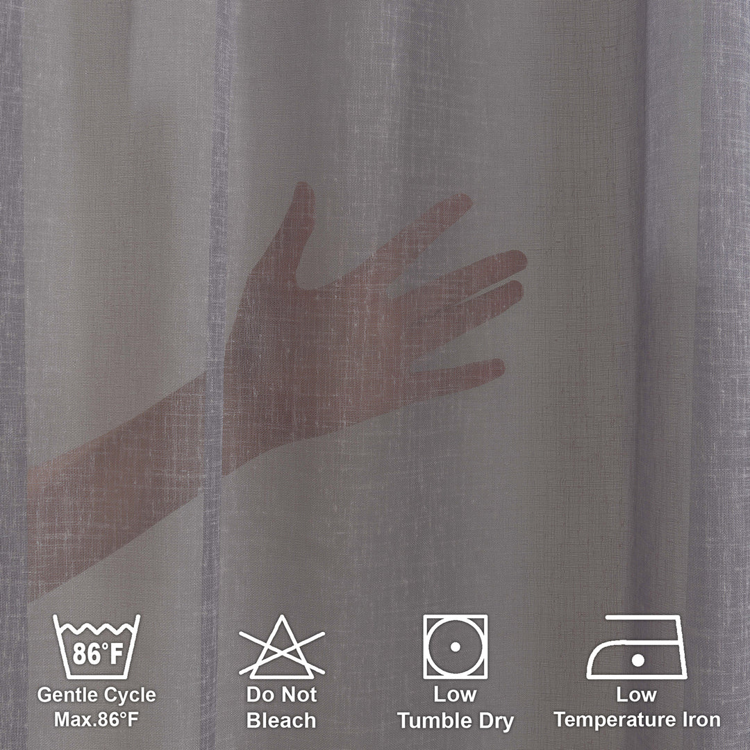 Washing label and fabric detail of grey linen sheer curtain showing weave and care instructions.