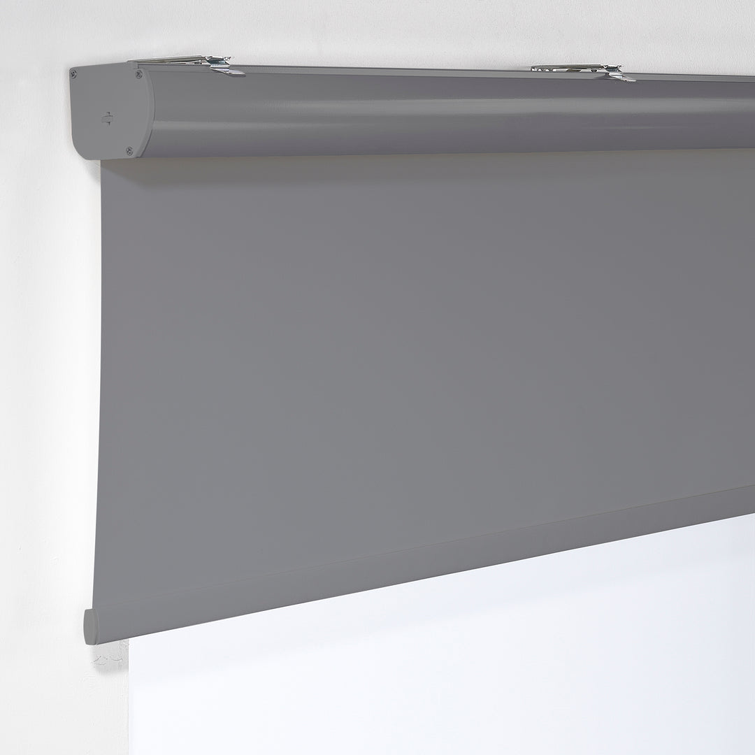 A grey room darkening roller blind made to measure, photographed with a soft matte texture and tidy straight lines providing gentle light reduction