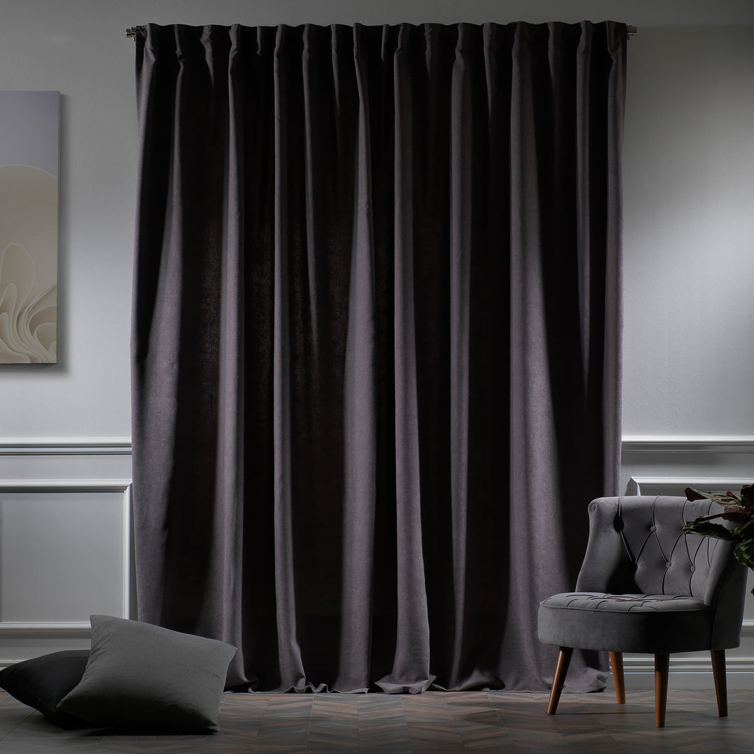 Grey velour curtains photographed at night, showing cool tone, dense weave and elegant soft drape.