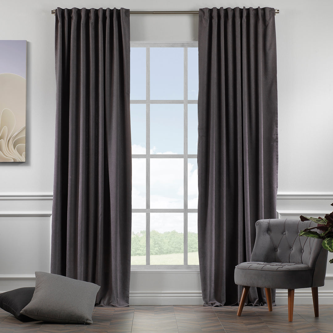 Grey velour curtains shown in daylight, highlighting smooth pile texture and refined neutral tone.