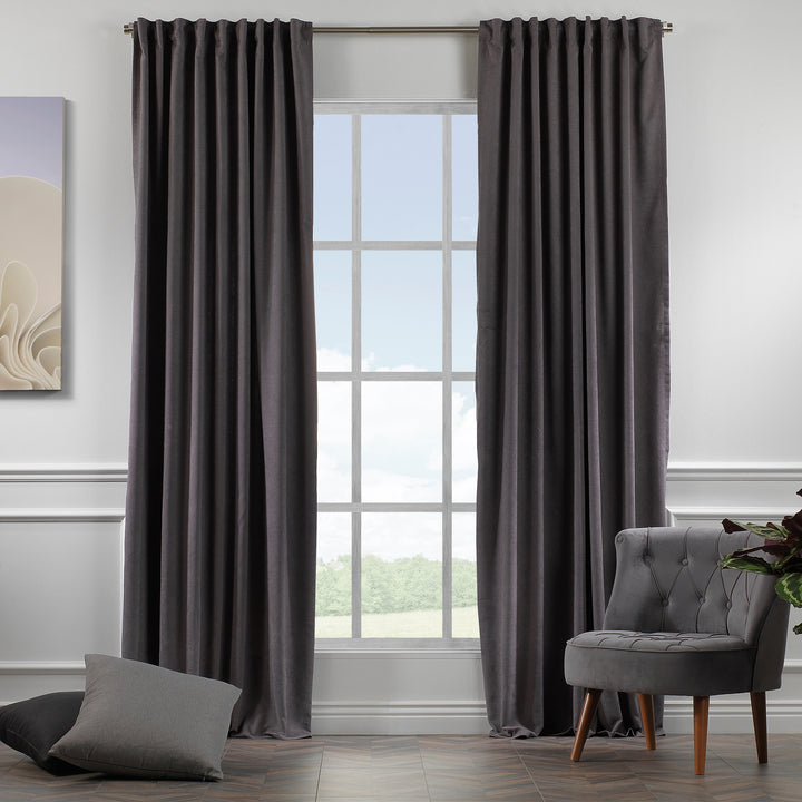 Grey velour curtains shown in daylight, highlighting smooth pile texture and refined neutral tone.