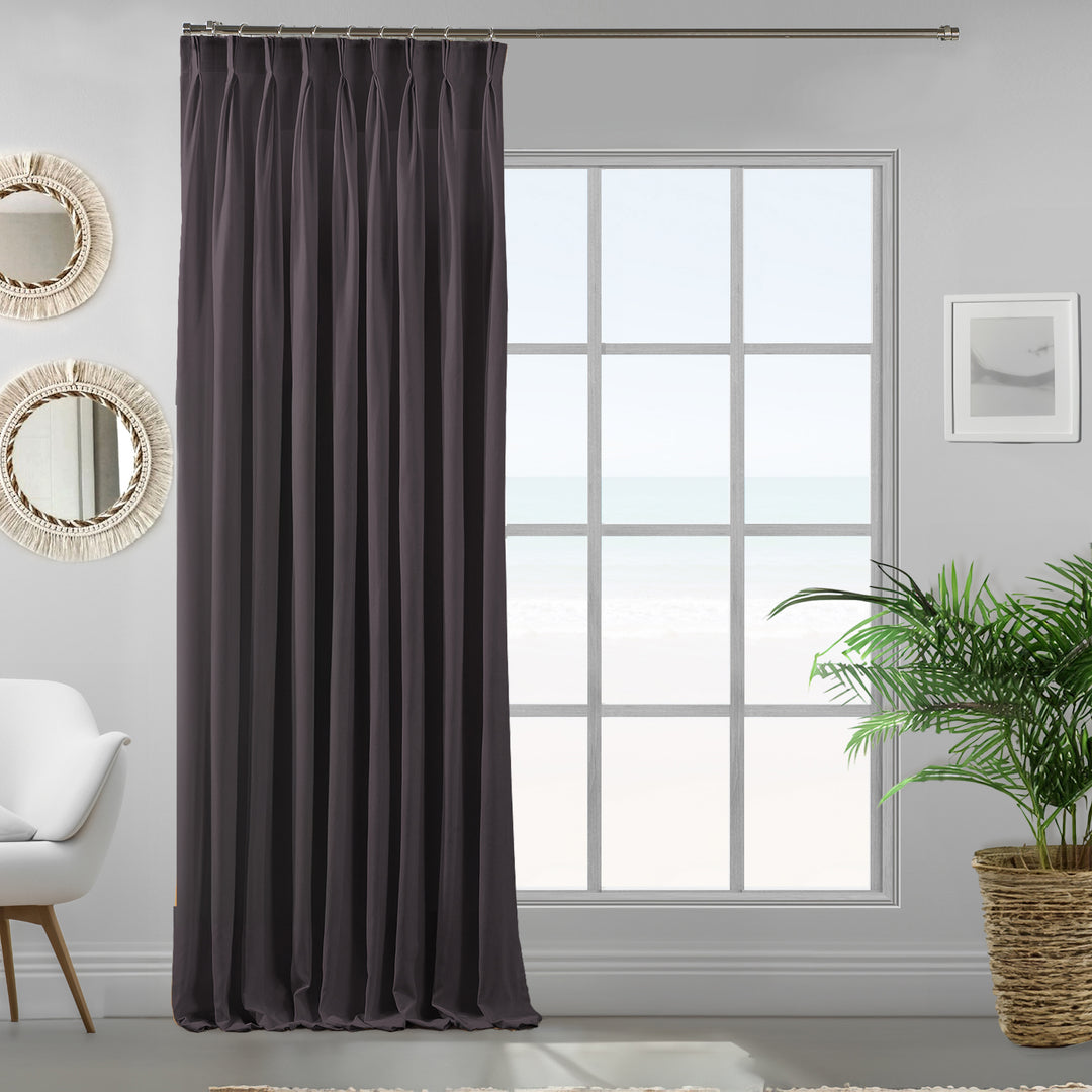 Pinch pleated grey velour curtain panel showing soft drape and premium matte finish.