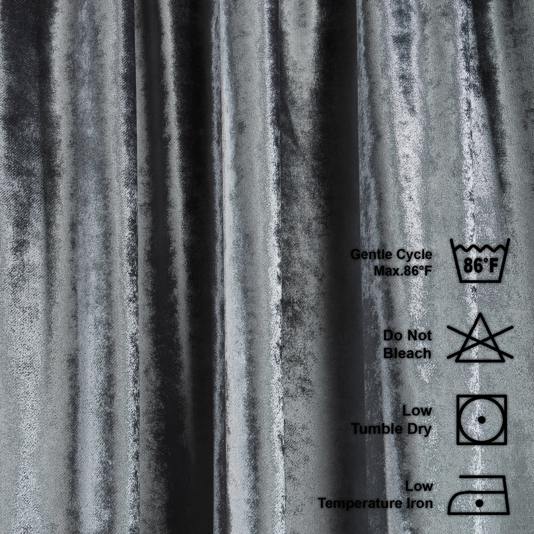 Washing instructions label on a textured grey shiny velvet background