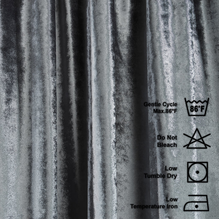 Washing instructions label on a textured grey shiny velvet background
