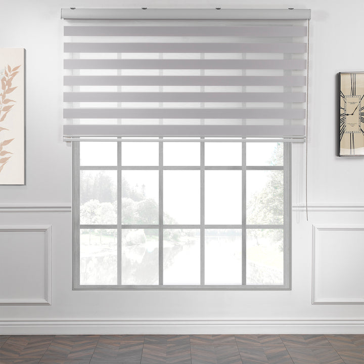 Made to measure solid silver zebra roller blind featuring subtle metallic‑toned alternating sheer and dim‑out stripes for sleek, adjustable light control and privacy, highlighting its light‑reflecting silver shade, smooth woven texture and contemporary day‑and‑night blind design.