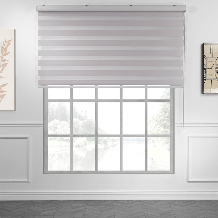 Made to measure solid silver zebra roller blind featuring subtle metallic‑toned alternating sheer and dim‑out stripes for sleek, adjustable light control and privacy, highlighting its light‑reflecting silver shade, smooth woven texture and contemporary day‑and‑night blind design.