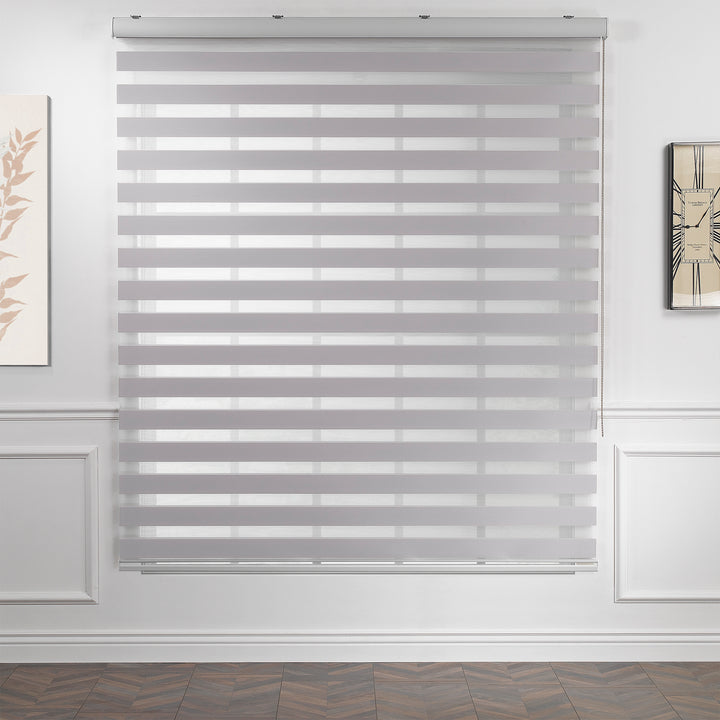 Made to measure solid silver zebra roller blind featuring subtle metallic‑toned alternating sheer and dim‑out stripes for sleek, adjustable light control and privacy, highlighting its light‑reflecting silver shade, smooth woven texture and contemporary day‑and‑night blind design.