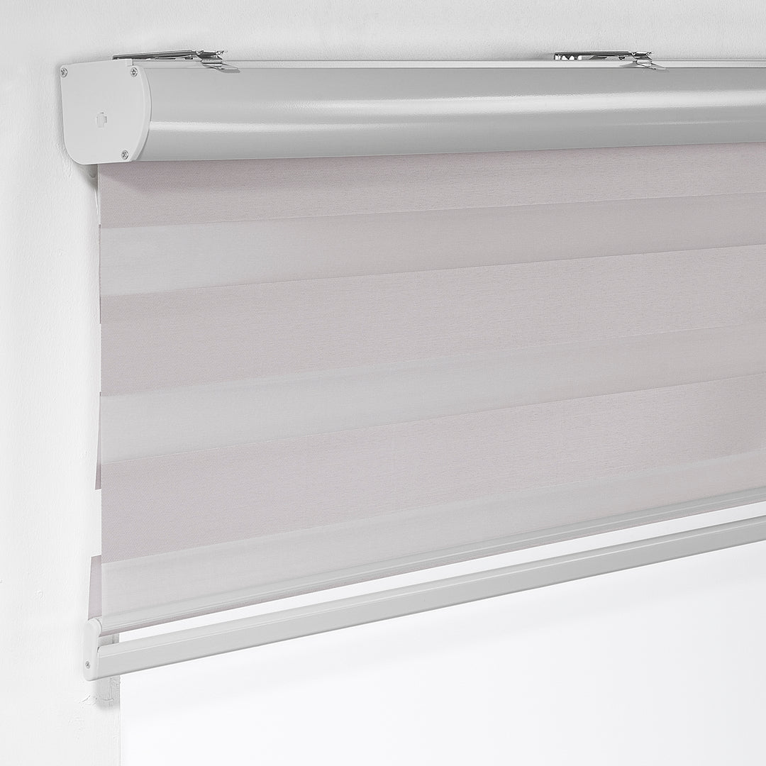 Made to measure solid silver zebra roller blind featuring subtle metallic‑toned alternating sheer and dim‑out stripes for sleek, adjustable light control and privacy, highlighting its light‑reflecting silver shade, smooth woven texture and contemporary day‑and‑night blind design.