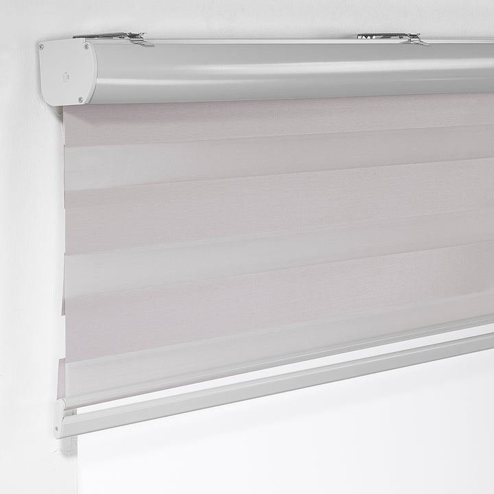 Made to measure solid silver zebra roller blind featuring subtle metallic‑toned alternating sheer and dim‑out stripes for sleek, adjustable light control and privacy, highlighting its light‑reflecting silver shade, smooth woven texture and contemporary day‑and‑night blind design.
