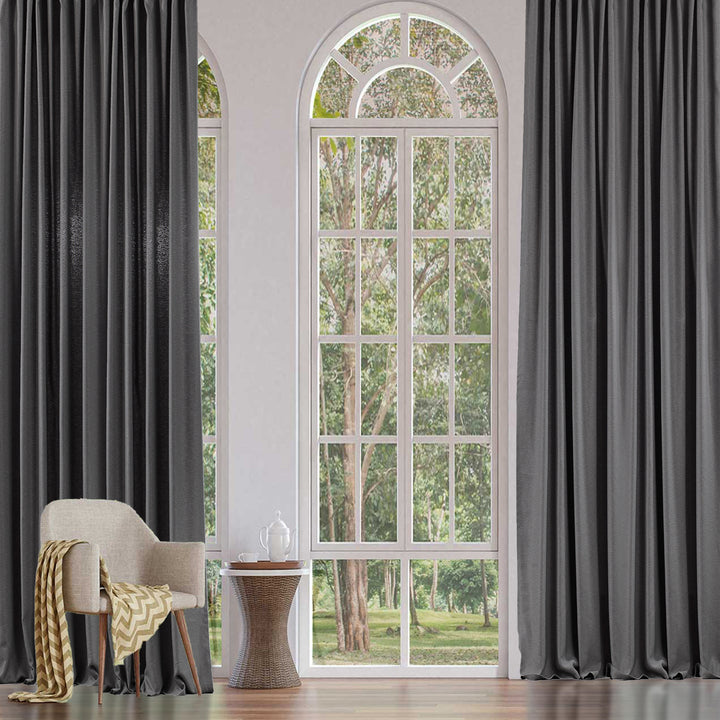 An extra‑long wide linen‑look door curtain in light grey, showing smooth tailored folds, airy daylight texture and a refined finish