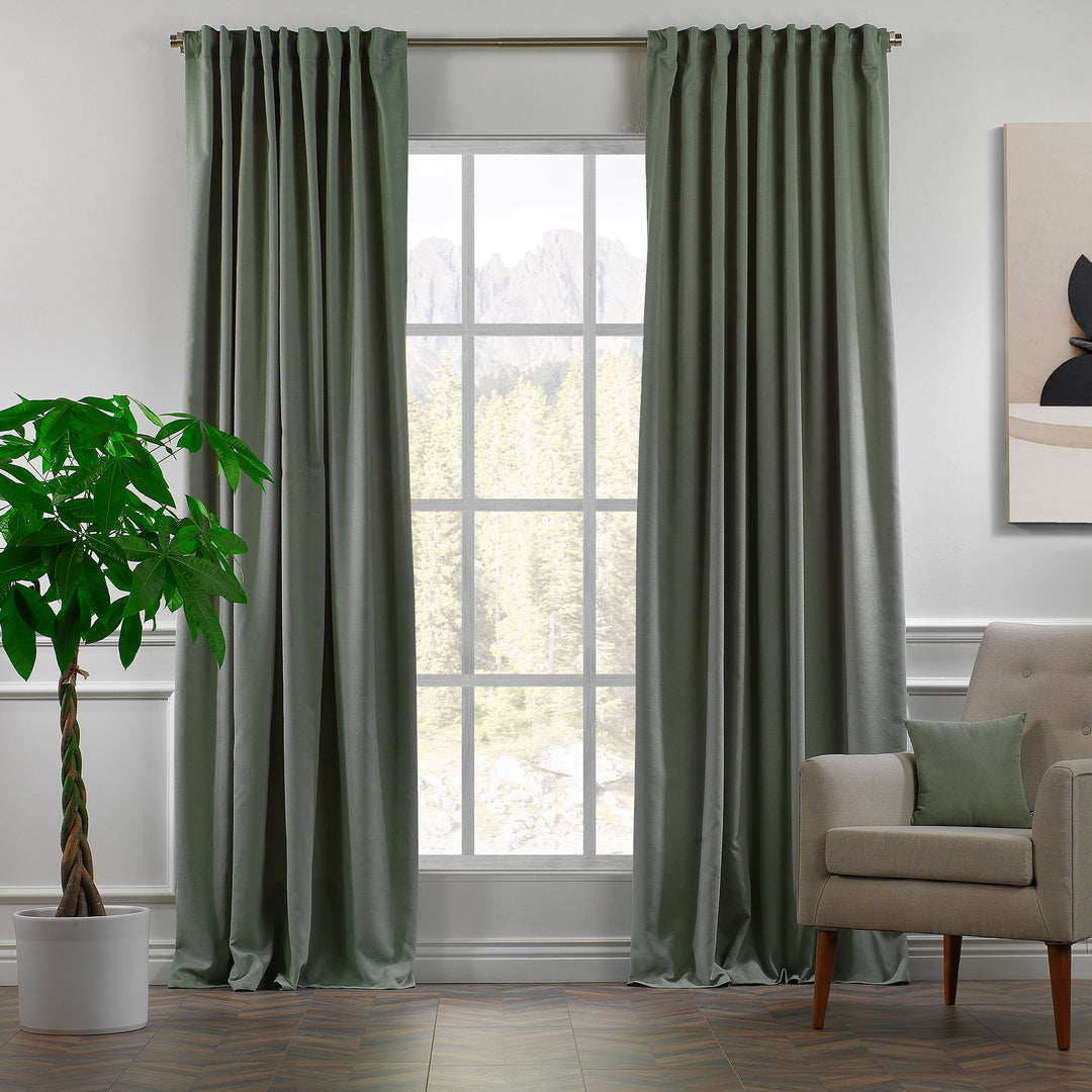Leaf green velour curtains shown in daylight, highlighting smooth pile texture and fresh natural tone.