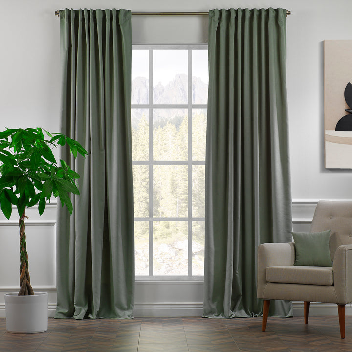 Leaf green velour curtains shown in daylight, highlighting smooth pile texture and fresh natural tone.