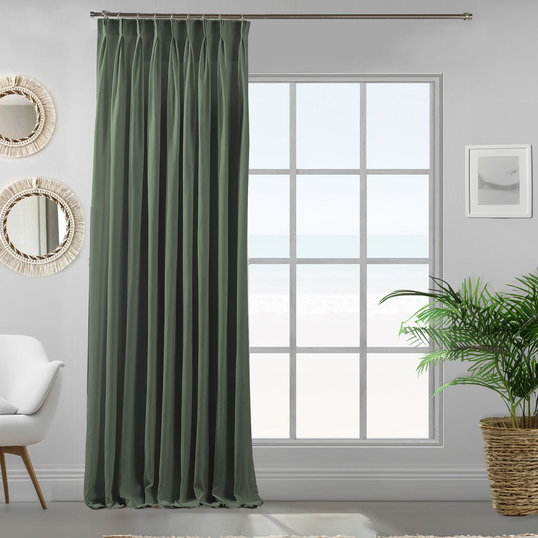 Pinch pleated leaf green velour curtain panel showing soft drape and refined matte finish.