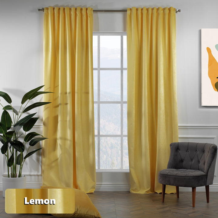 Soft yellow velvet eyelet curtain panel with long relaxed fall.