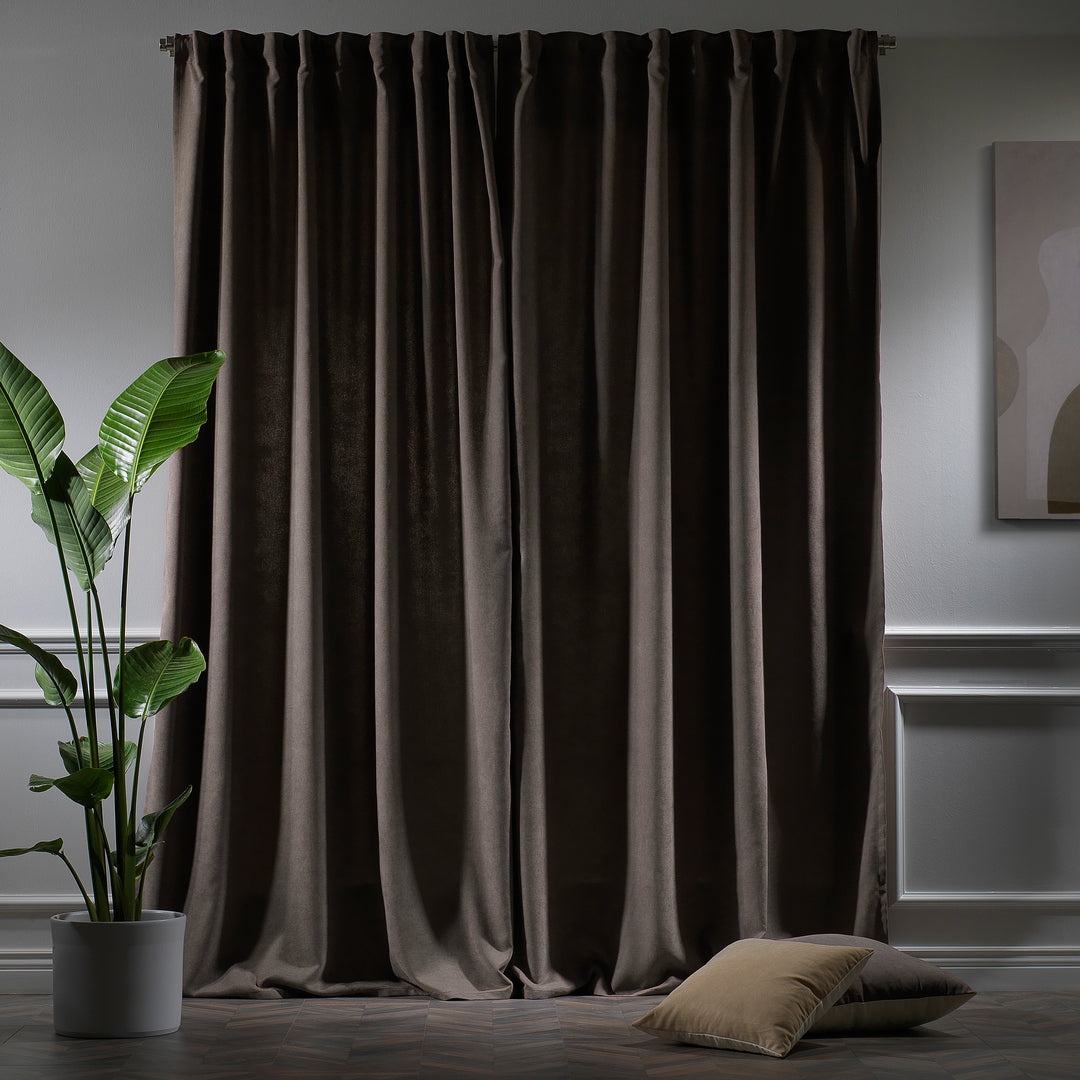 Light brown velour curtains photographed at night, showing warm tone, dense weave and elegant soft drape.