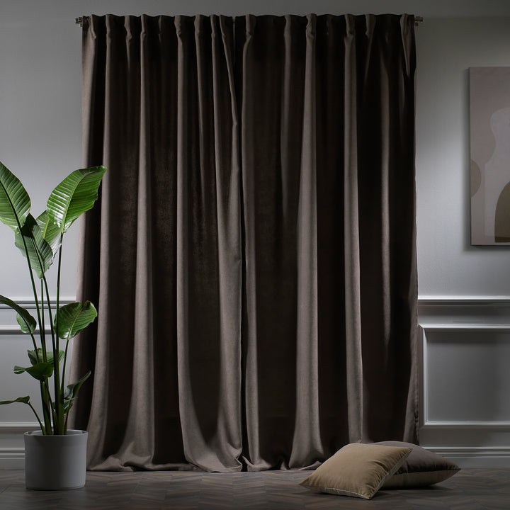 Light brown velour curtains photographed at night, showing warm tone, dense weave and elegant soft drape.