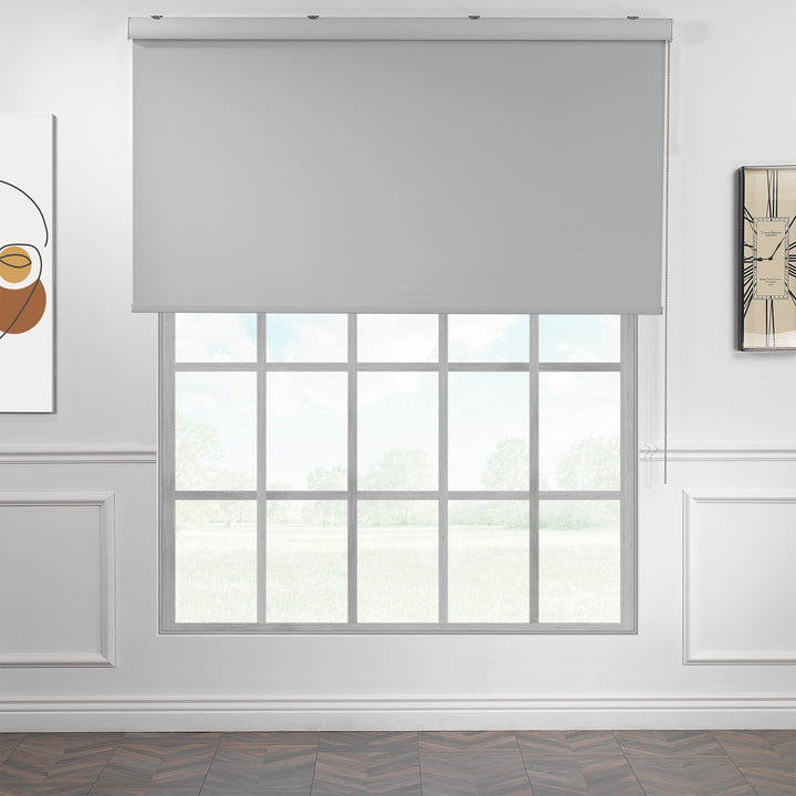 A made to measure light grey room darkening roller blind displayed with a soft matte texture and tidy straight lines offering balanced dimming